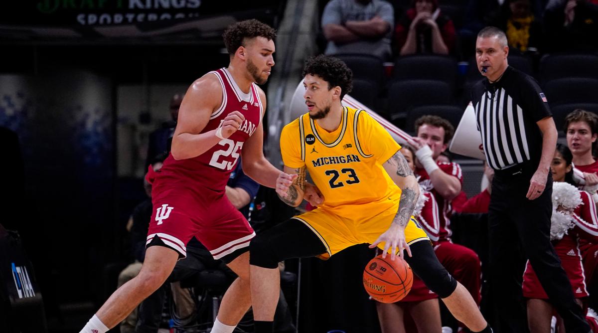 Michigan forward Brandon Johns Jr. (23) drives on Indiana forward Race Thompson (25) in the first half of an NCAA college basketball game at the Big Ten Conference tournament in Indianapolis, Thursday, March 10, 2022.
