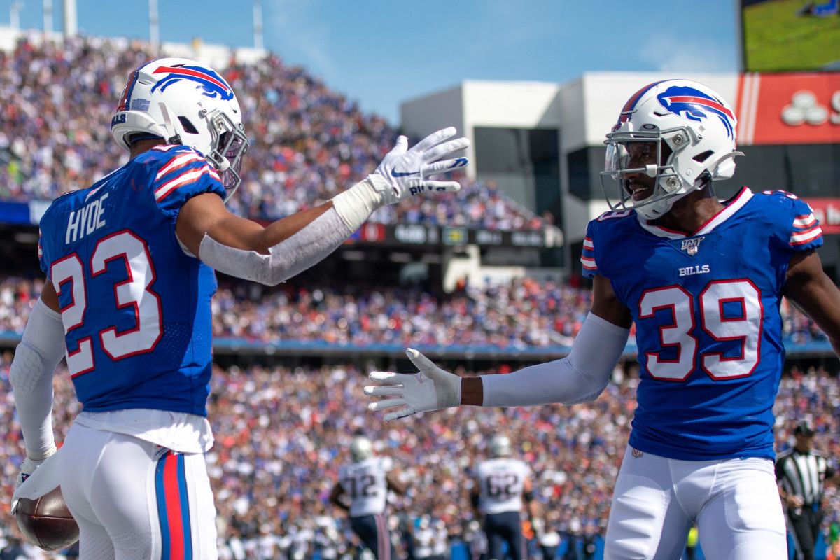 Buffalo Bills strong safety Micah Hyde (23) celebrates with teammate defensive back Levi Wallace (39) after his interception in the end zone during the second quarter against the New England Patriots at New Era Field.
