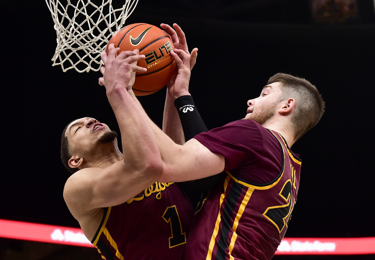Mar 6, 2022; St. Louis, MO, USA; Loyola Ramblers guard Lucas Williamson (1) and guard Tate Hall (24) grab a rebound against the Drake Bulldogs during the second half in the finals of the Missouri Valley Conference Tournament at Enterprise Center. Mandatory Credit: Jeff Curry-USA TODAY Sports