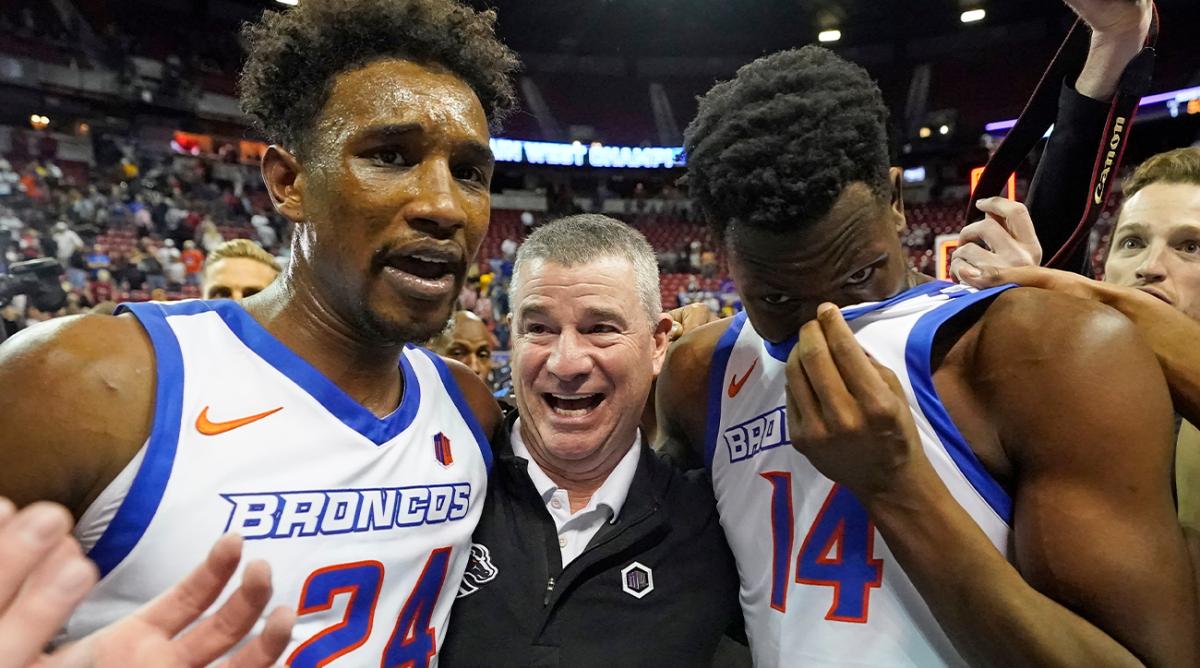 Boise State’s Abu Kigab (24) and Emmanuel Akot (14) celebrates with coach Leon Rice following their victory over San Diego State in an NCAA college basketball game in the finals of Mountain West Conference men’s tournament Saturday, March 12, 2022, in Las Vegas.
