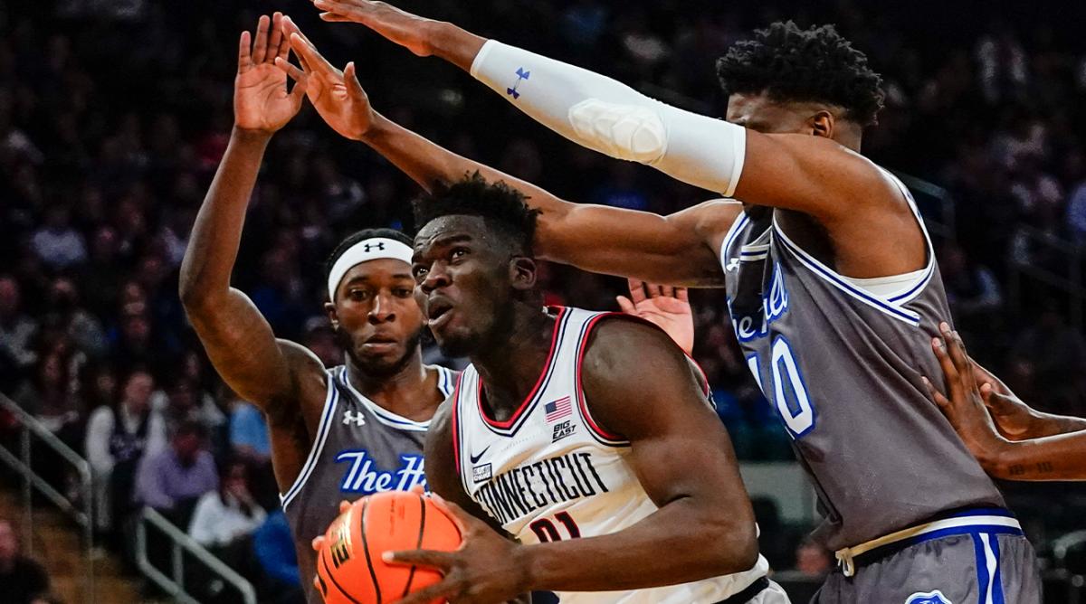 Seton Hall’s Myles Cale, left, and Alexis Yetna, right, defend against Connecticut’s Adama Sanogo during the first half of an NCAA college basketball game at the Big East conference tournament Thursday, March 10, 2022, in New York.