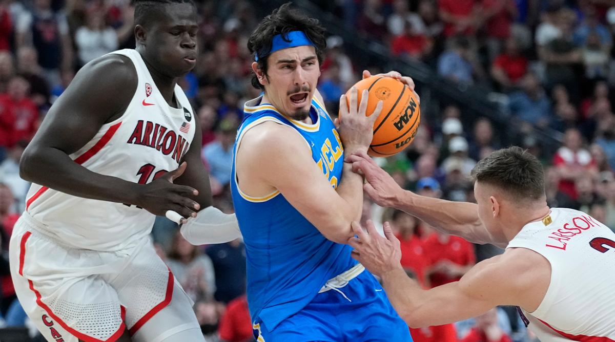 UCLA’s Jaime Jaquez Jr. (24) drives through Arizona’s Oumar Ballo, left, and Arizona’s Pelle Larsson (3) during the second half of an NCAA college basketball game in the championship of the Pac-12 tournament Saturday, March 12, 2022, in Las Vegas.