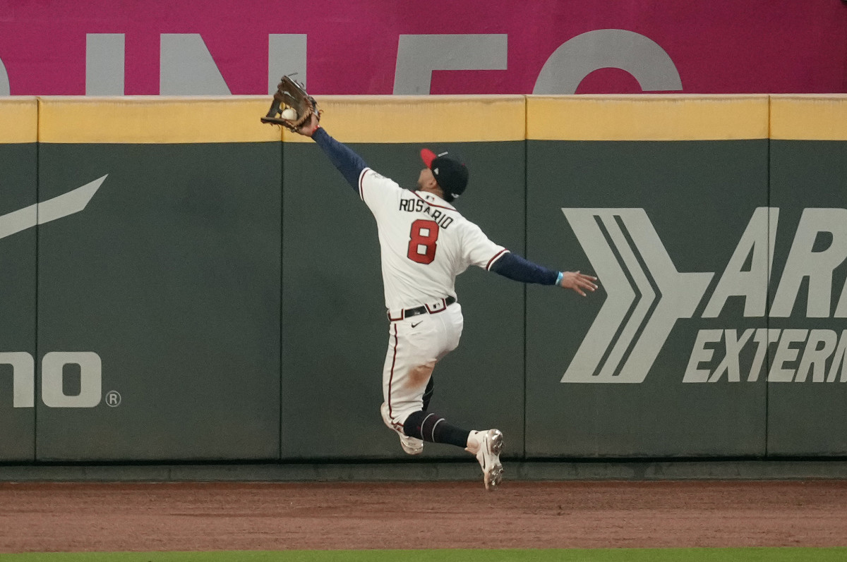 Atlanta Braves outfielder Eddie Rosario makes a leaping play during 2021 World Series.