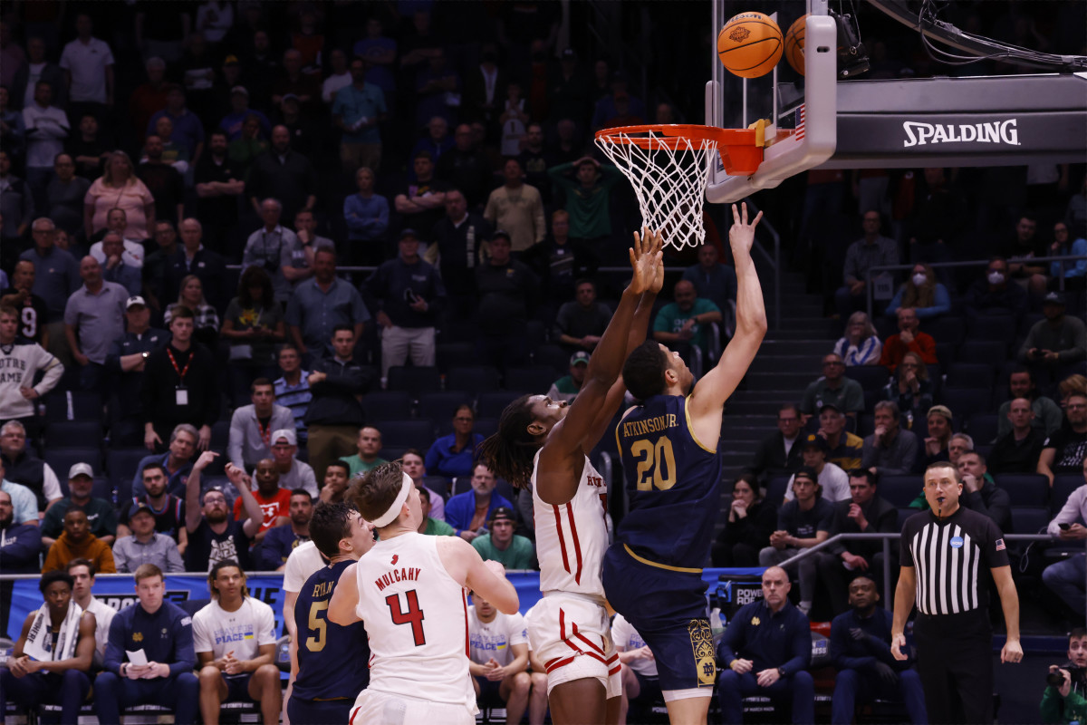 Notre Dame Fighting Irish forward Paul Atkinson Jr. (20) makes a basket over Rutgers Scarlet Knights center Clifford Omoruyi (11) in over time at University of Dayton Arena.