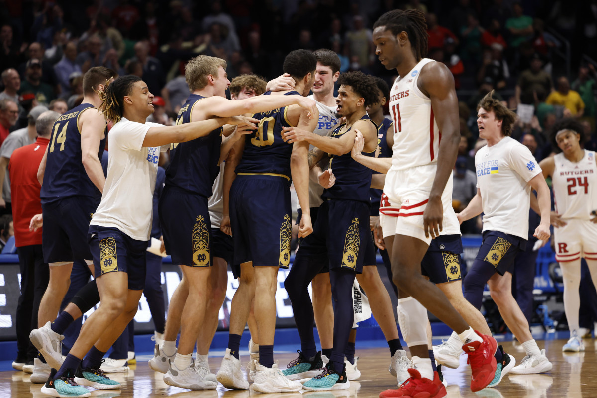 Notre Dame Fighting Irish storm the court after defeating Rutgers Scarlet Knights in over time at University of Dayton Arena.