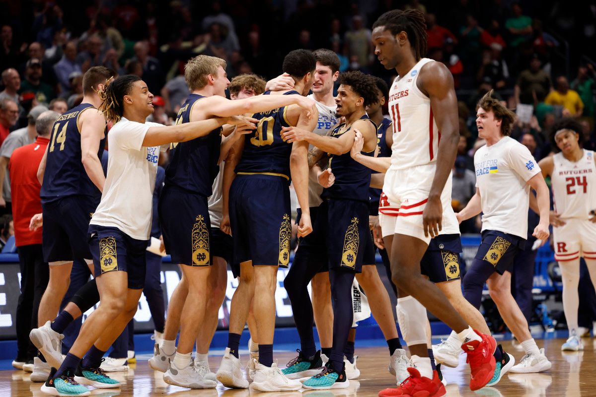 Notre Dame Fighting Irish storm the court after defeating Rutgers Scarlet Knights in over time at University of Dayton Arena.