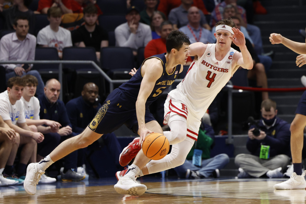 Notre Dame Fighting Irish guard Cormac Ryan (5) drives to the basket defended by Rutgers Scarlet Knights guard Paul Mulcahy (4) in the second half at University of Dayton Arena.