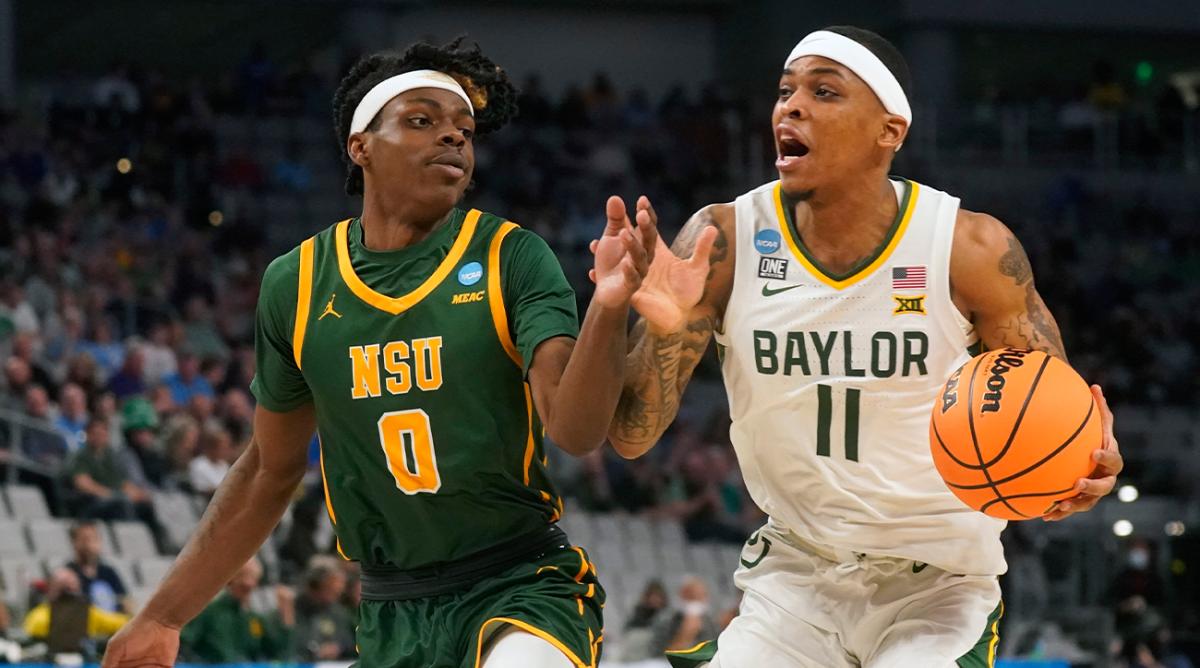Baylor guard James Akinjo (11) drives against Norfolk State guard Christian Ings (0) during the first half of a college basketball game in the first round of the NCAA tournament in Fort Worth, Texas, Thursday, March 17, 2022.