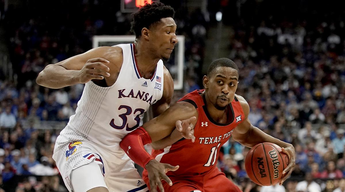 Kansas forward David McCormack (33) pressures Texas Tech forward Bryson Williams (11) during the first half of an NCAA college basketball championship game of the Big 12 Conference tournament in Kansas City, Mo., Saturday, March 12, 2022.