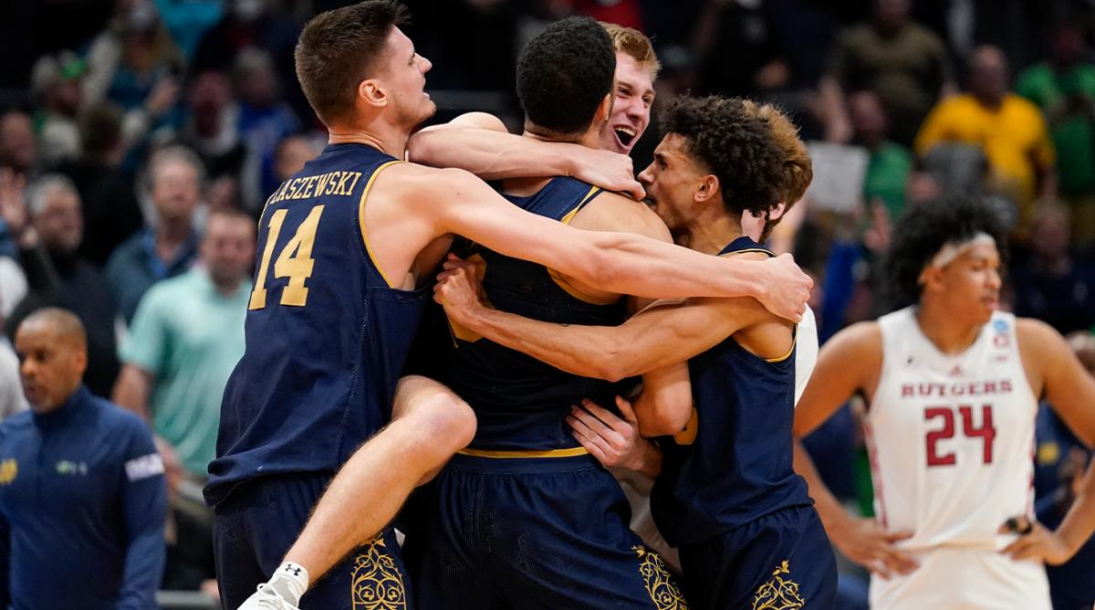 Notre Dame players celebrate after defeating Rutgers 89-87 in double overtime in a First Four game in the NCAA men’s college basketball tournament, early Thursday, March 17, 2022, in Dayton, Ohio.