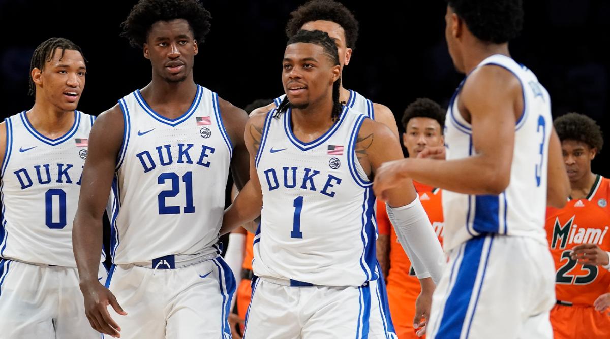 Duke’s AJ Griffin (21) and Duke’s Trevor Keels (1) walk arm-in-arm in the finals seconds of the second half of an NCAA college basketball game against Miami during semifinals of the Atlantic Coast Conference men’s tournament, Friday, March 11, 2022, in New York.