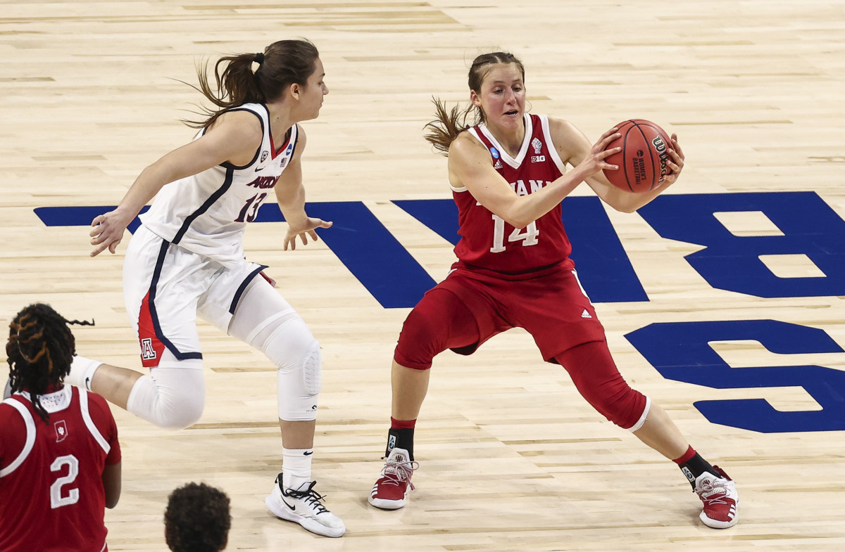 Mar 29, 2021; San Antonio, Texas, USA; Indiana Hoosiers guard Ali Patberg (14) controls the ball as Arizona Wildcats guard Helena Pueyo (13) defends during the second quarter in the Elite Eight of the 2021 Women's NCAA Tournament at Alamodome. Mandatory Credit: Troy Taormina-USA TODAY Sports