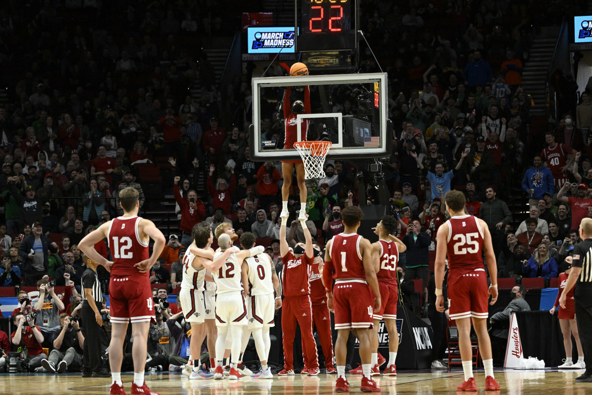 An IU cheerleader retrieves a stuck ball during Indiana's first round game versus Saint Mary's.