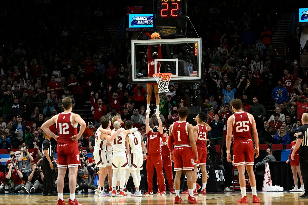 An IU cheerleader retrieves a stuck ball during Indiana's first round game versus Saint Mary's.