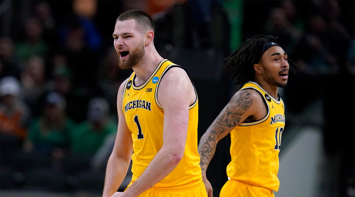 Michigan center Hunter Dickinson (1) celebrates with teammate Frankie Collins, right, during the second half of a college basketball game against Colorado State in the first round of the NCAA tournament in Indianapolis, Thursday, March 17, 2022.