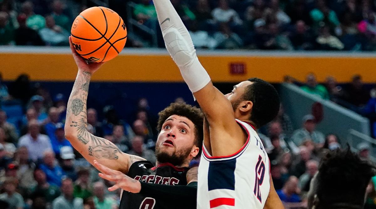 New Mexico State guard Teddy Allen (0) shoots against Connecticut forward Tyler Polley (12) during the second half of a college basketball game in the first round of the NCAA men’s tournament Thursday, March 17, 2022, in Buffalo, N.Y.