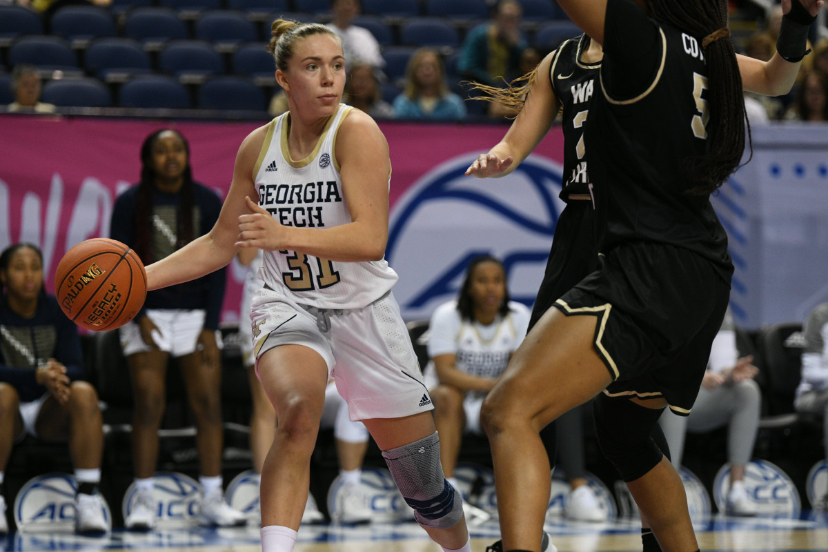 Mar 3, 2022; Greensboro, North Carolina, USA; Georgia Tech Yellow Jackets guard Lotta-Maj Lahtinen (31) passes while doubled teamed by Wake Forest Demon Deacons defenders during the third quarter at Greensboro Coliseum Complex. Mandatory Credit: William Howard-USA TODAY Sports
