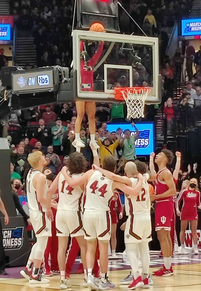 Indiana cheerleader Cassidy Cerny grabs the ball off the top of the backboard. 