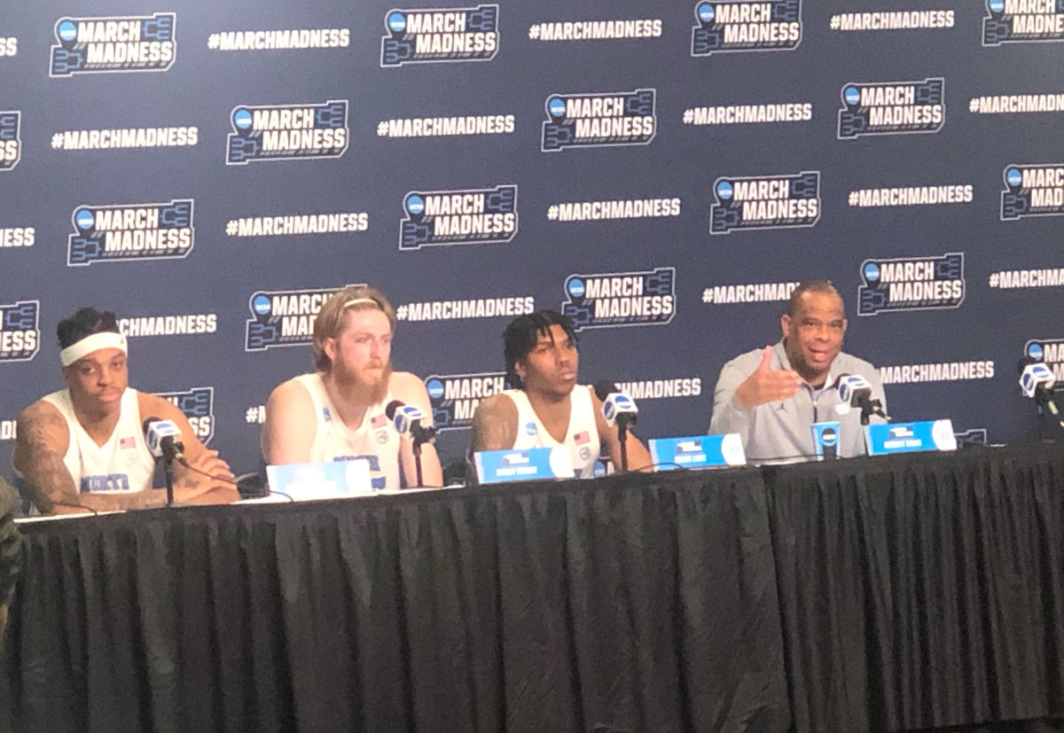Photo of UNC players and head coach at the post-game press conference