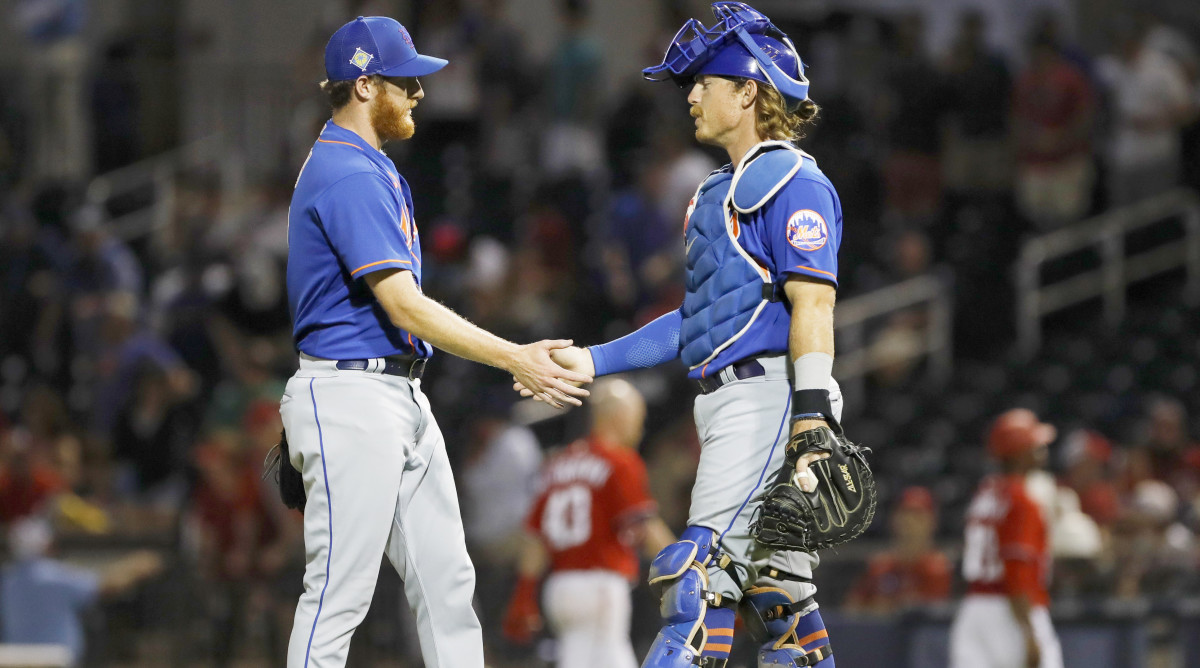 Mar 19, 2022; West Palm Beach, Florida, USA; New York Mets pitcher Trey Cobb (13) celebrate with catcher Nick Meyer after winning the game against the Washington Nationals during spring training at The Ballpark of the Palm Beaches.