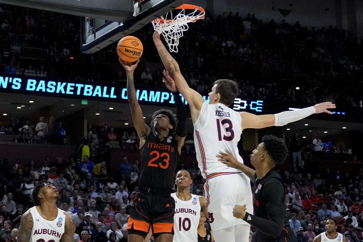 Mar 20, 2022; Greenville, SC, USA; Miami (Fl) Hurricanes guard Kameron McGusty (23) drives to the basket against Auburn Tigers forward Walker Kessler (13) in the second half during the second round of the 2022 NCAA Tournament at Bon Secours Wellness Arena. Mandatory Credit: Jim Dedmon-USA TODAY Sports