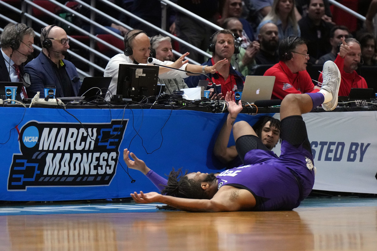 Mar 20, 2022; San Diego, CA, USA; TCU Horned Frogs guard Micah Peavy (0) and center Eddie Lampkin (4) crash into the barriers after going for a loose ball against Arizona Wildcats guard Pelle Larsson (not pictured) in the first half during the second round of the 2022 NCAA Tournament at Viejas Arena.