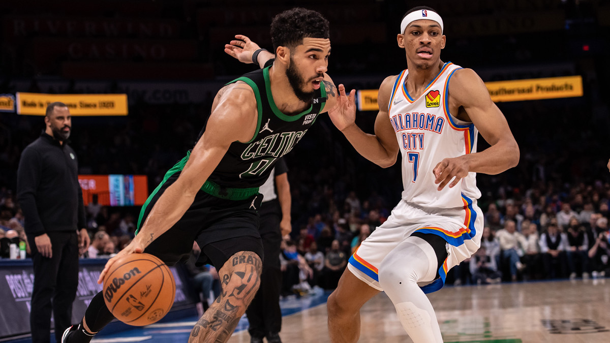 Boston Celtics forward Jayson Tatum dribbles past Oklahoma City Thunder forward Darius Bazley.