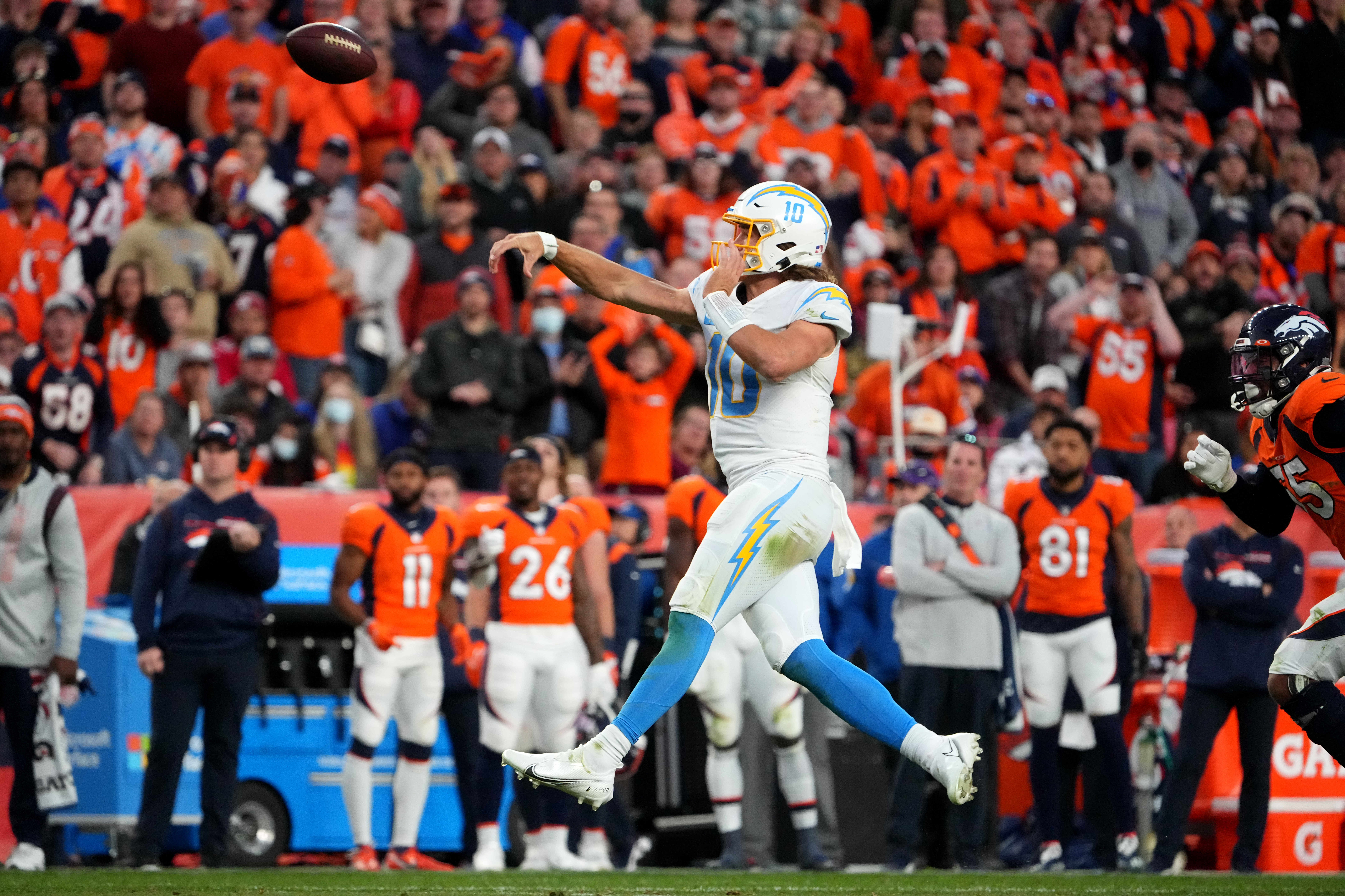 Nov 28, 2021; Denver, Colorado, USA; Los Angeles Chargers quarterback Justin Herbert (10) passes the ball in the fourth quarter against the Denver Broncos at Empower Field at Mile High. Mandatory Credit: Ron Chenoy-USA TODAY Sports