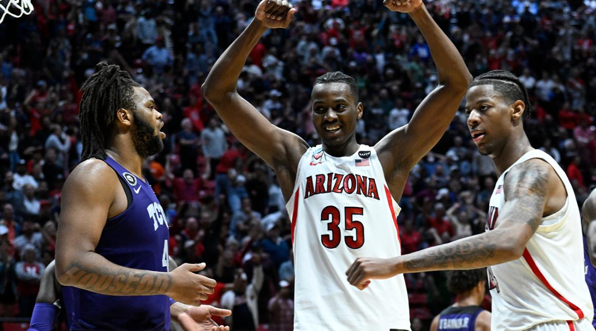 Arizona center Christian Koloko (35) reacts as Arizona guard Dalen Terry, right, stands across from TCU center Eddie Lampkin, left, at the end of overtime in a second-round NCAA college basketball tournament game, Sunday, March 20, 2022, in San Diego. Arizona won 85-80 in overtime.