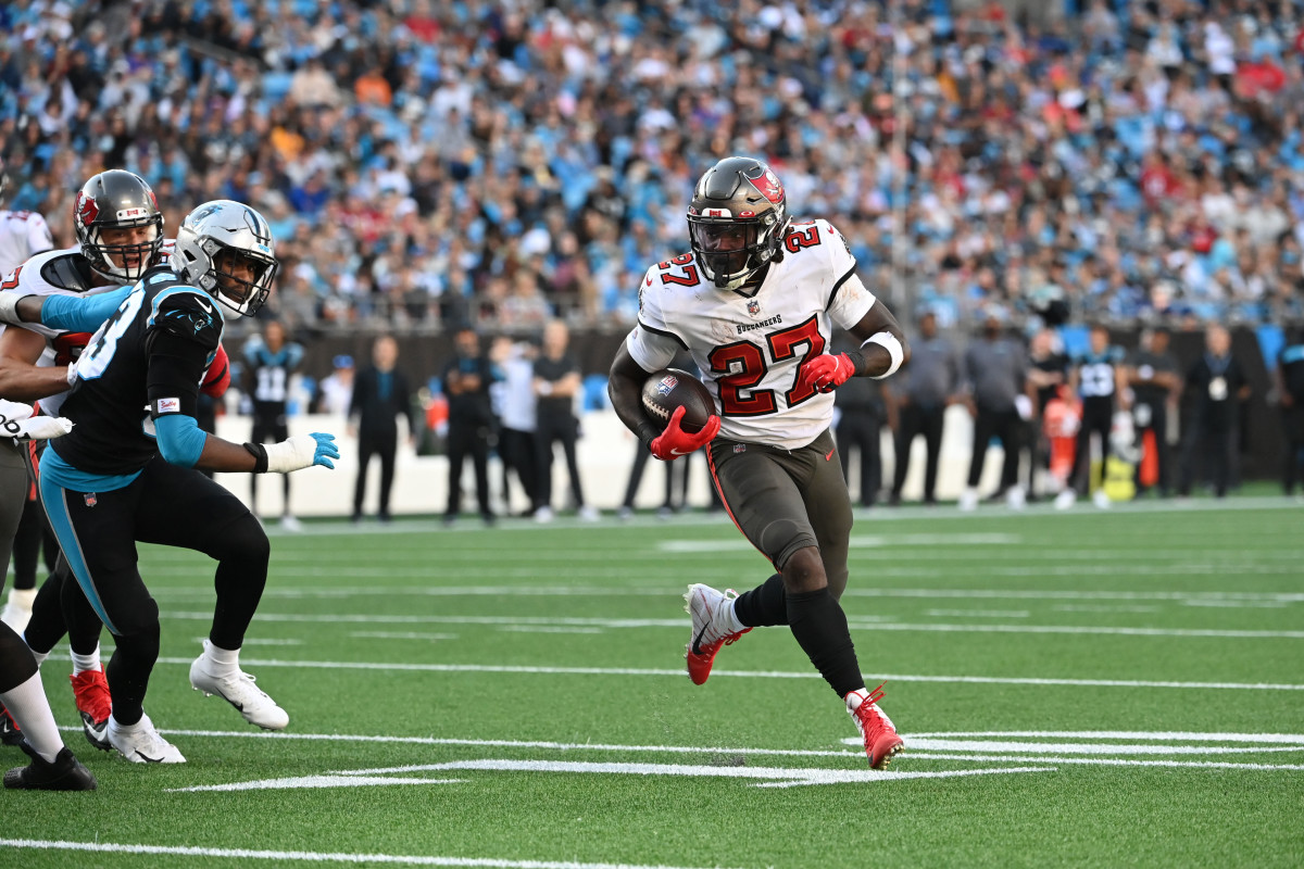 Dec 26, 2021; Charlotte, North Carolina, USA; Tampa Bay Buccaneers running back Ronald Jones (27) runs for a touchdown as Carolina Panthers defensive end Brian Burns (53) defends in the third quarter at Bank of America Stadium. Mandatory Credit: Bob Donnan-USA TODAY Sports