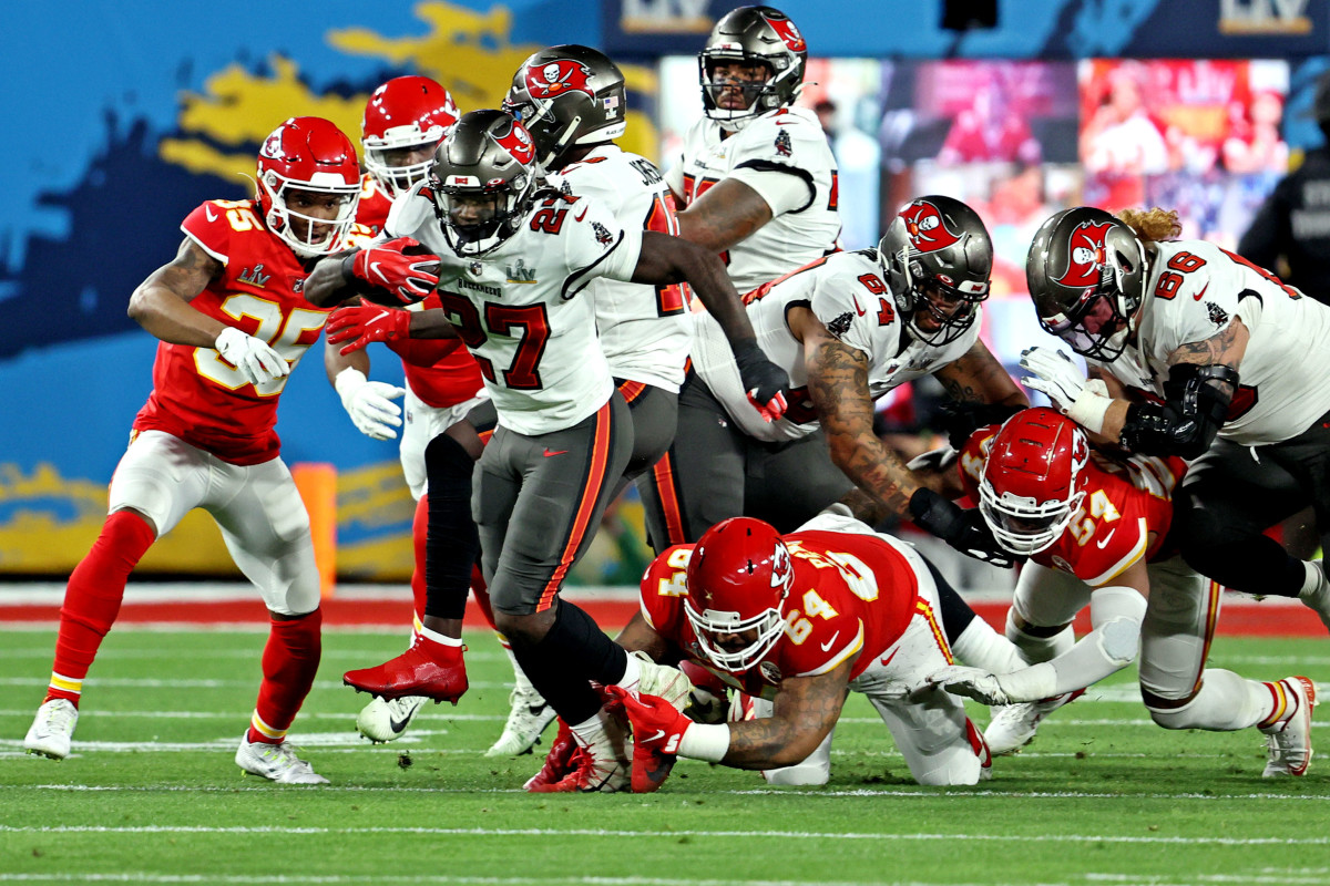 Feb 4, 2020; Tampa, FL, USA; Tampa Bay Buccaneers running back Ronald Jones (27) runs the ball against Kansas City Chiefs defensive tackle Mike Pennel (64) during the first quarter in Super Bowl LV at Raymond James Stadium. Mandatory Credit: Matthew Emmons-USA TODAY Sports