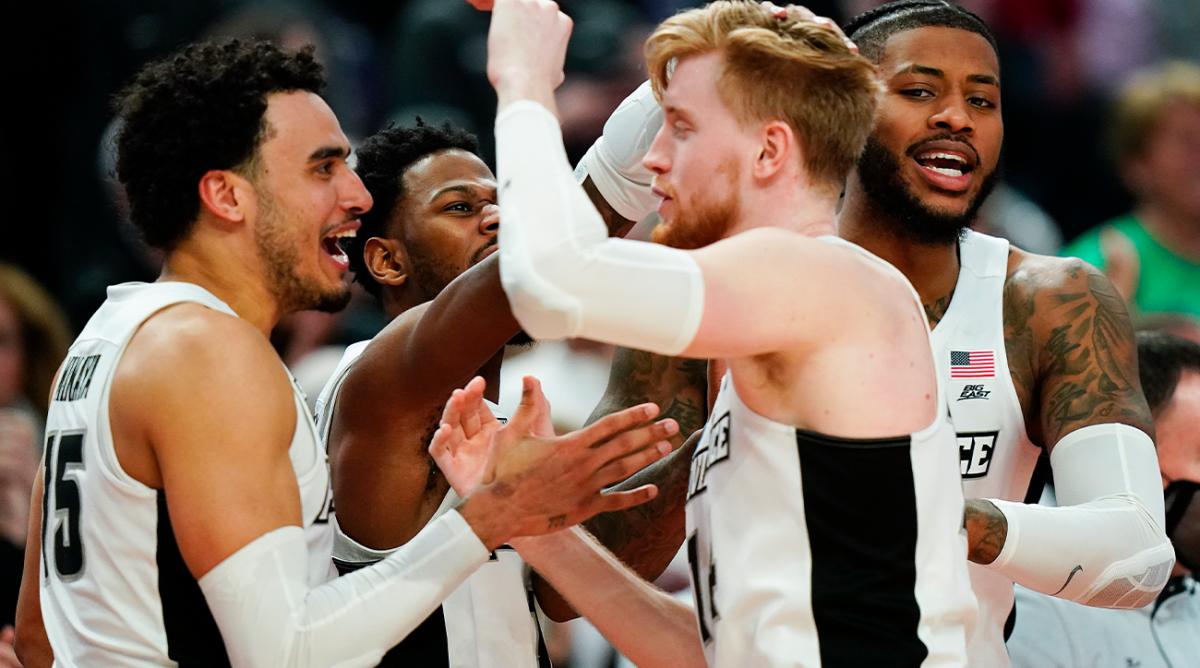 Providence players celebrate on the sideline late in the college basketball game against Richmond in the second round of the NCAA men’s tournament Saturday, March 19, 2022, in Buffalo, N.Y.