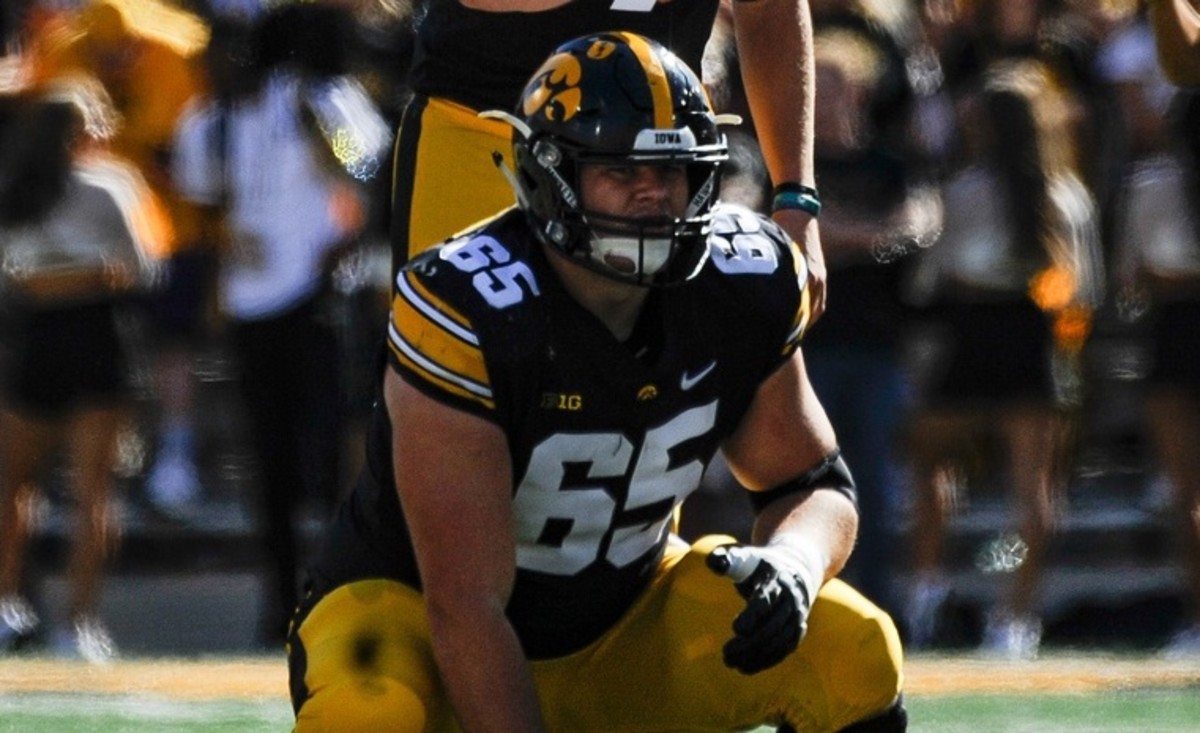 Sep 25, 2021; Iowa City, Iowa, USA; Iowa Hawkeyes quarterback Spencer Petras (7) and offensive lineman Tyler Linderbaum (65) in action against the Colorado State Rams at Kinnick Stadium. Mandatory Credit: Jeffrey Becker-USA TODAY Sports