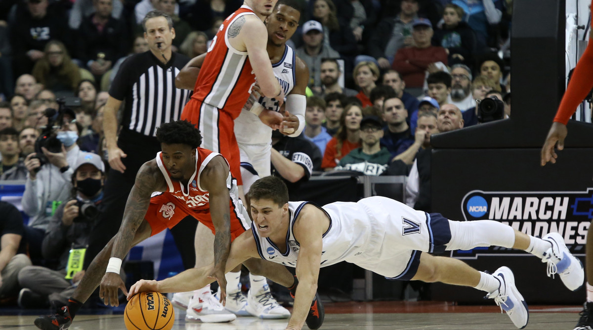 Villanova Wildcats guard Collin Gillespie (2) and Ohio State Buckeyes guard Jamari Wheeler (55) attempt to get a loose ball in the second half during the second round of the 2022 NCAA Tournament at PPG Paints Arena.
