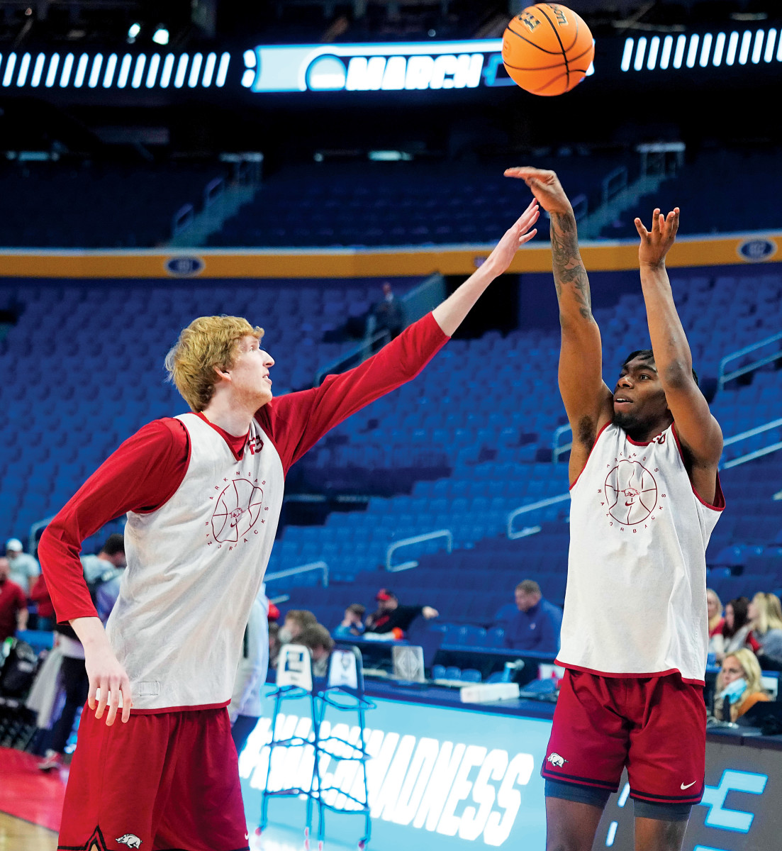 Razorbacks forward Kamani Johnson (20) shoots the ball with forward Connor Vanover (23) defending during practice before the first round of the 2022 NCAA Tournament at KeyBank Center.