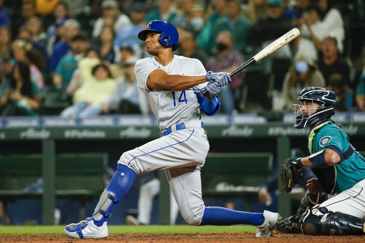 Aug 27, 2021; Seattle, Washington, USA; Kansas City Royals center fielder Edward Olivares (14) hits a two-run home run against the Seattle Mariners during the twelfth inning at T-Mobile Park. Seattle Mariners catcher Tom Murphy (2) watches at right. Mandatory Credit: Joe Nicholson-USA TODAY Sports