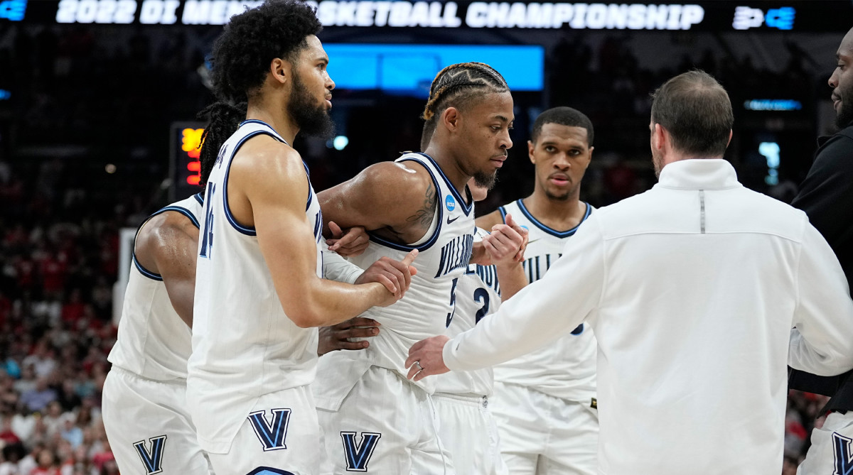Villanova guard Justin Moore (5) is helped off the floor during the second half of a college basketball game against Houston in the Elite Eight round of the NCAA tournament on Saturday, March 26, 2022, in San Antonio.