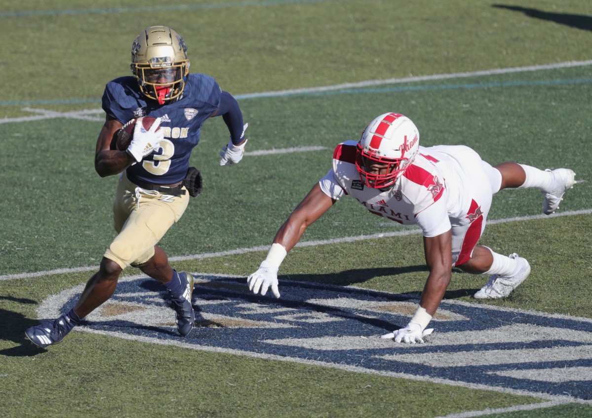 University of Akron's Michael Mathison gets past Miami Redhawks Dominique Robinson after a first quarter pass on Saturday, Nov. 28, 2020 in Akron, Ohio, at InfoCision Stadium. [Phil Masturzo/ Beacon Journal] Zips Miami3