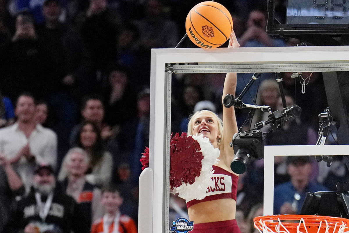 An Arkansas Razorbacks cheerleader knocks the ball loose from the backboard during the second half of the game between the Arkansas Razorbacks and the Duke Blue Devils in the finals of the West regional of the men's college basketball NCAA Tournament at Chase Center.