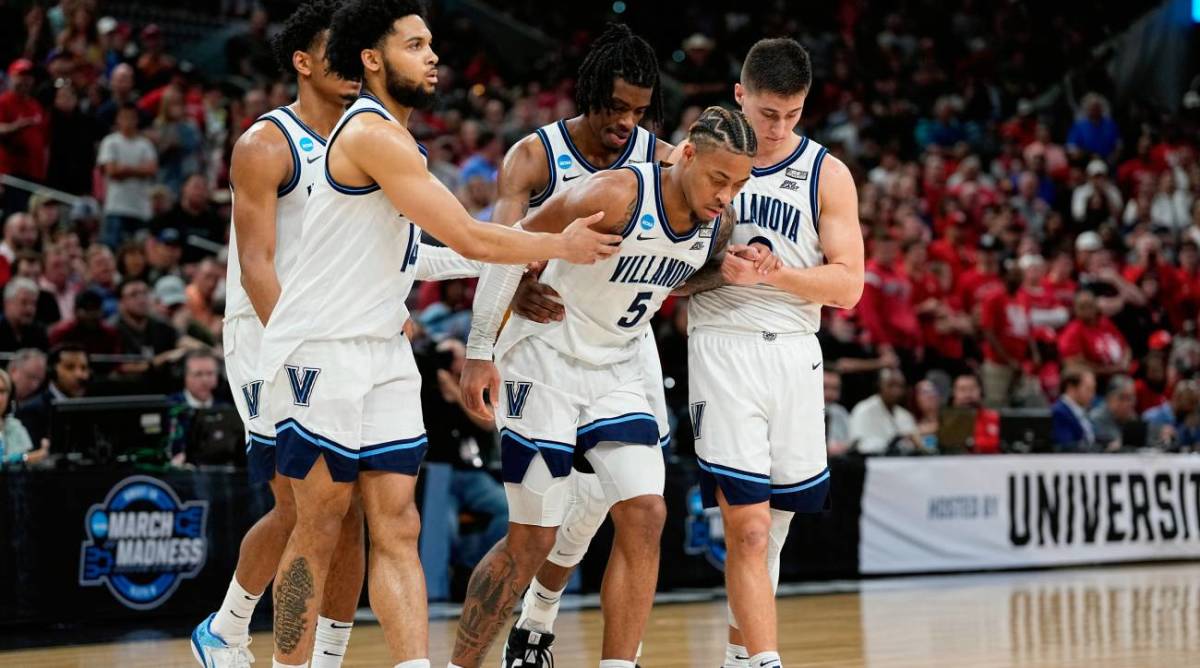 Villanova guard Justin Moore (5) is helped off the floor during the second half of a college basketball game against Houston in the Elite Eight round of the NCAA tournament on Saturday, March 26, 2022, in San Antonio.