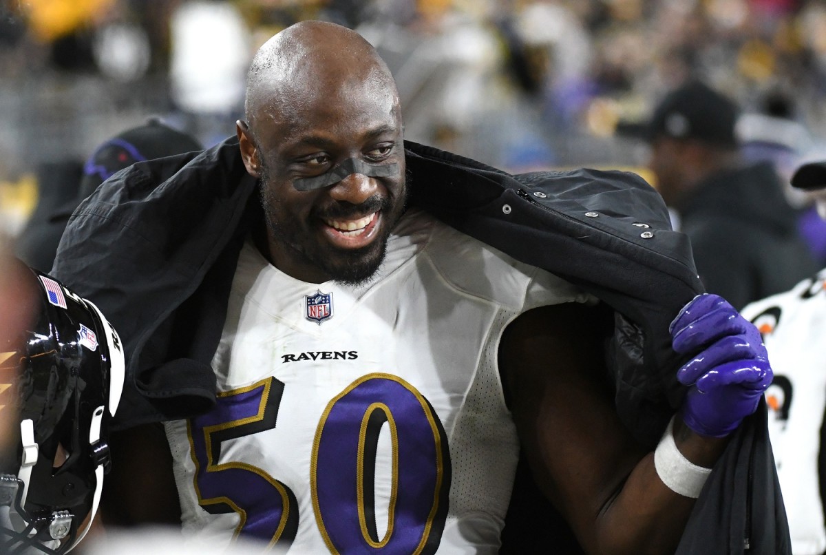 Dec 5, 2021; Pittsburgh, Pennsylvania, USA; Baltimore Ravens linebacker Justin Houston (50) smiles on the sidelines during the third quarter against the Pittsburgh Steelers at Heinz Field.