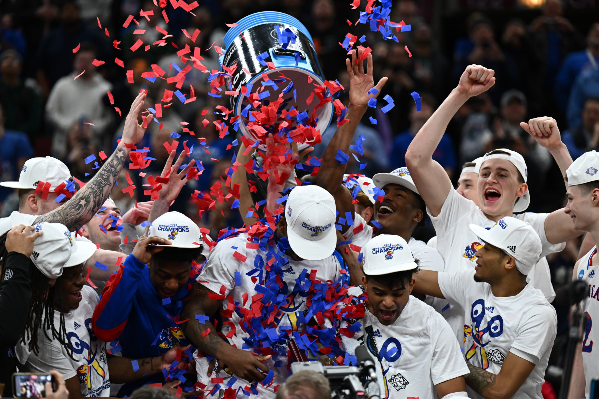 Mar 27, 2022; Chicago, IL, USA; Kansas Jayhawks players celebrate after advancing to the Final Four by defeating the Miami Hurricanes 76-50 in the finals of the Midwest regional of the men's college basketball NCAA Tournament at United Center.