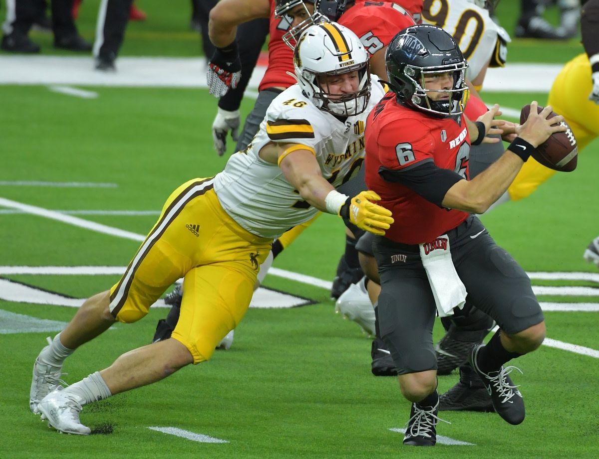 Wyoming Cowboys linebacker Chad Muma (48) sacks UNLV Rebels quarterback Max Gilliam (6) during the second quarter at Allegiant Stadium.