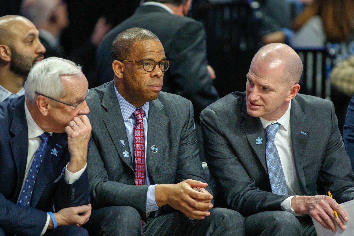 Davis, center, was an assistant coach under Roy Williams, left, from 2012 until taking over as head coach this season.