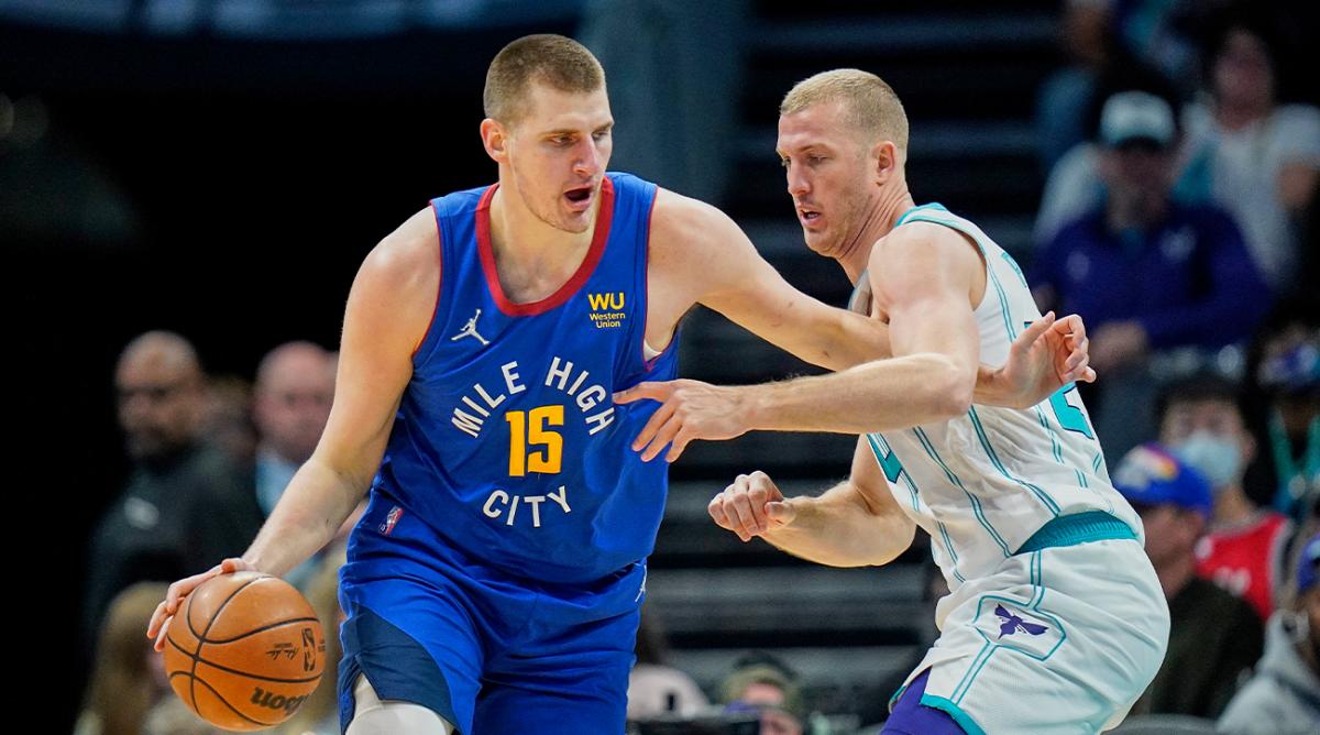 Denver Nuggets center Nikola Jokic (15) goes to the basket against Charlotte Hornets center Mason Plumlee, right, during the first half of an NBA basketball game on Monday, March 28, 2022, in Charlotte, N.C.
