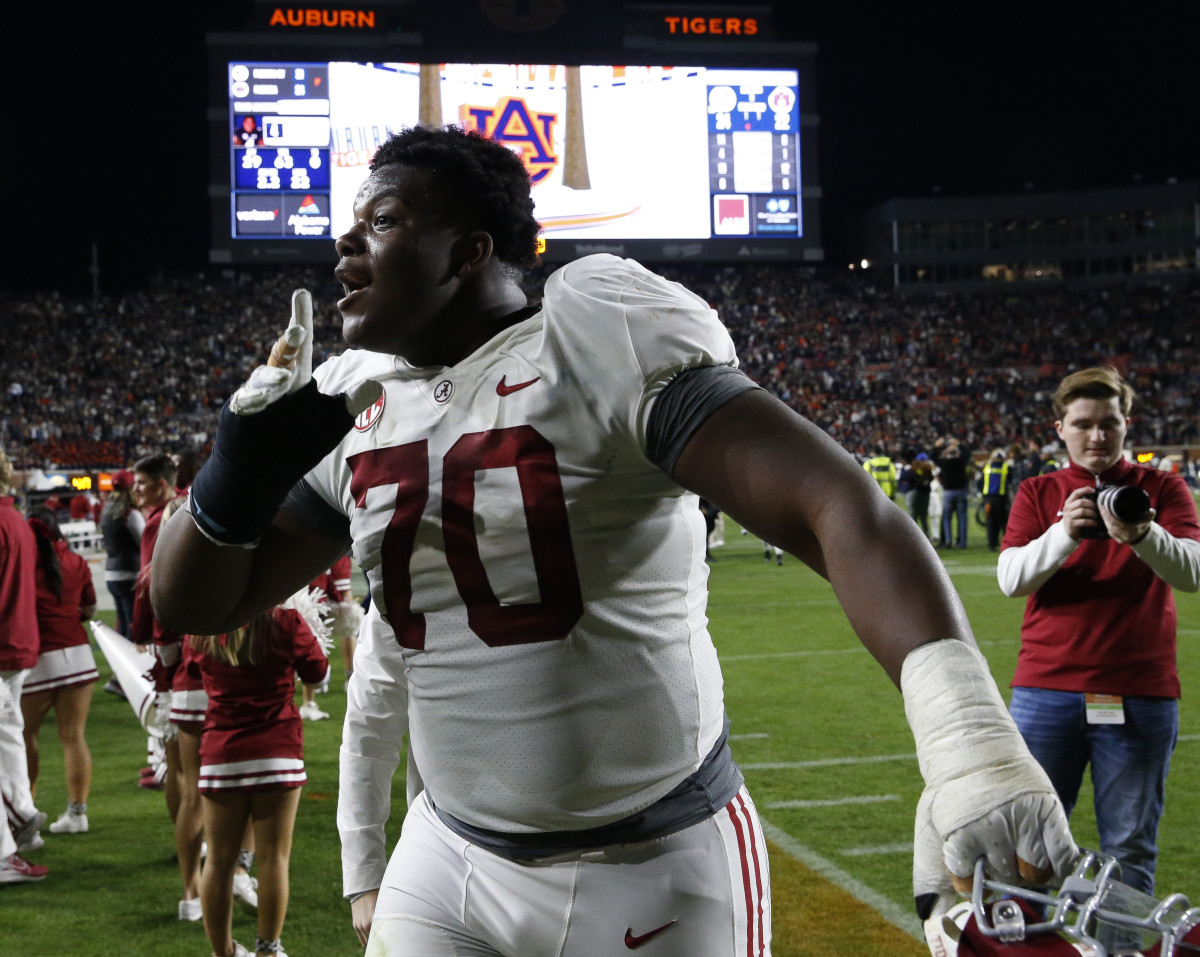 Alabama Crimson Tide offensive lineman Javion Cohen (70) celebrates as he leaves the filed after defeating the Auburn Tigers at Jordan-Hare Stadium. Alabama defeated Auburn in four overtimes.