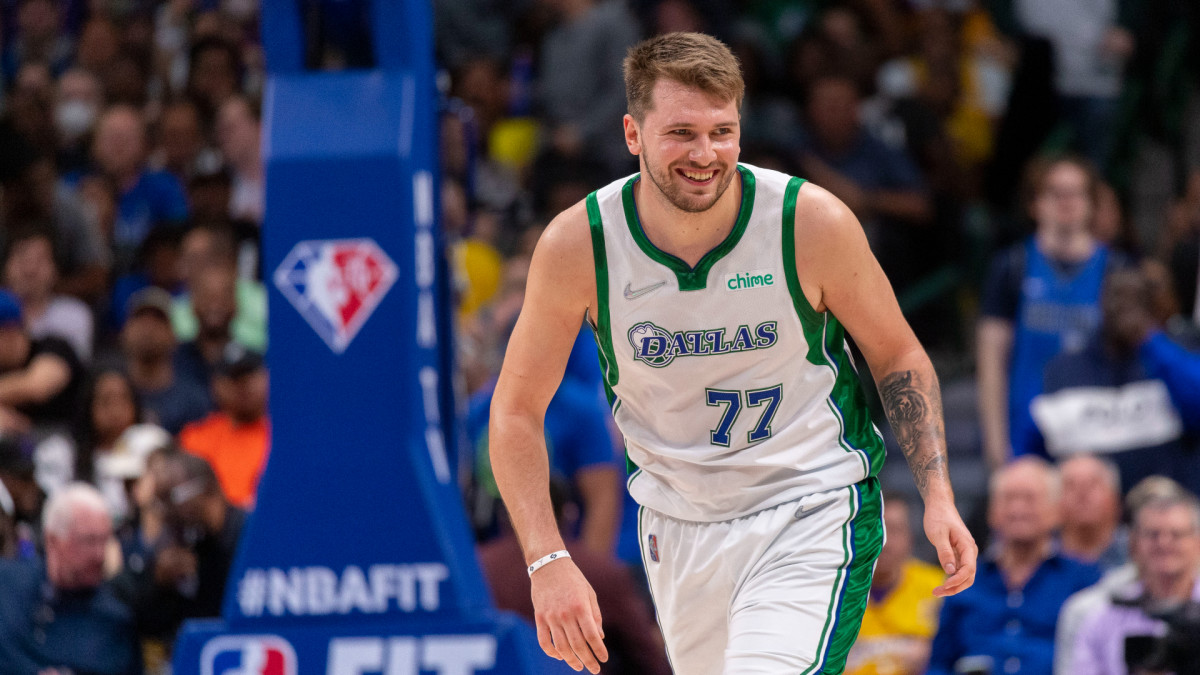 Mar 29, 2022; Dallas, Texas, USA; Dallas Mavericks guard Luka Doncic (77) smiles as he runs back up the court during the second half against the Los Angeles Lakers at the American Airlines Center. Mandatory Credit: Jerome Miron-USA TODAY Sports