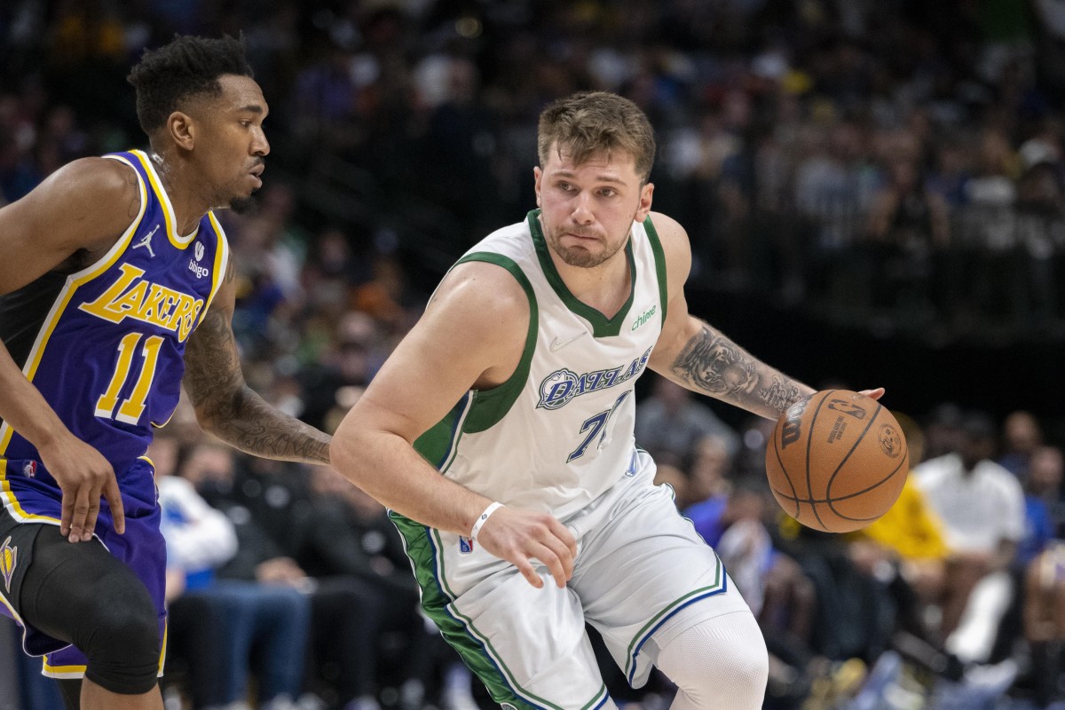 Mar 29, 2022; Dallas, Texas, USA; Dallas Mavericks guard Luka Doncic (77) drives to the basket past Los Angeles Lakers guard Malik Monk (11) during the second quarter at the American Airlines Center. Mandatory Credit: Jerome Miron-USA TODAY Sports