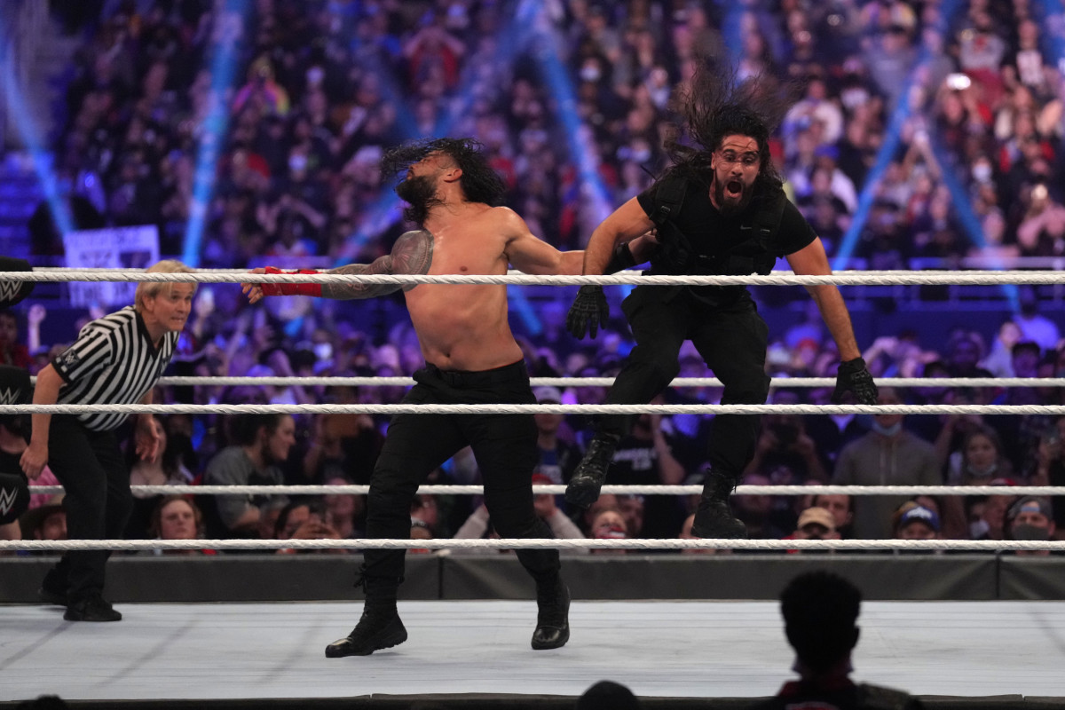 Jan 29, 2022; St. Louis, MO, USA; Roman Reigns (black pants) and Seth Rollins (black pants/top) wrestle during their WWE Universal Championship match at the Royal Rumble at The Dome at America's Center. Mandatory Credit: Joe Camporeale-USA TODAY Sports