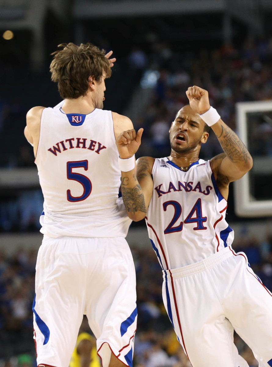 Mar 29, 2013; Arlington, TX, USA; Kansas Jayhawks guard Travis Releford (24) celebrates with center Jeff Withey (5) in the first half against the Michigan Wolverines during the semifinals of the South regional of the 2013 NCAA Tournament at Cowboys Stadium. Mandatory Credit: Matthew Emmons-USA TODAY Sports